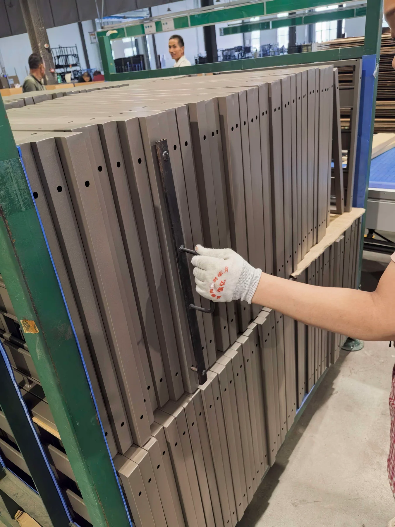 A gauge pin is used to check that laser-cut holes are clear through the frame section.